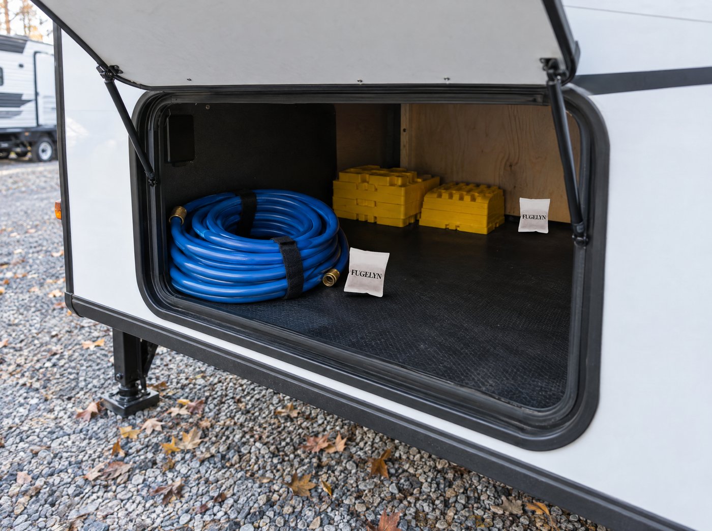 FUGELYN pouches in the open storage bay of a travel trailer